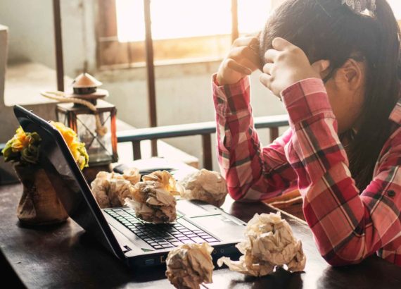 girl sitting at computer in frustration
