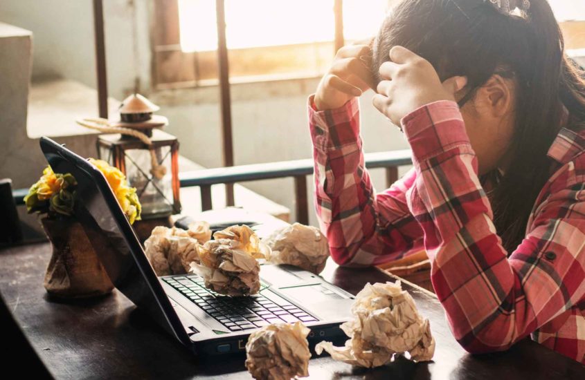 girl sitting at computer in frustration