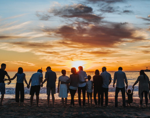 family in silhouette watching a sunset