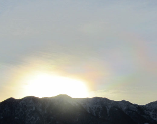 sun rising behind mountains