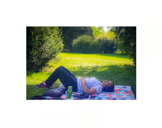 lying on a cloth on the grass in the park