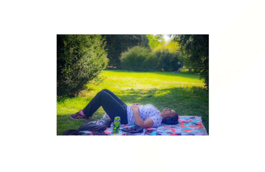 lying on a cloth on the grass in the park