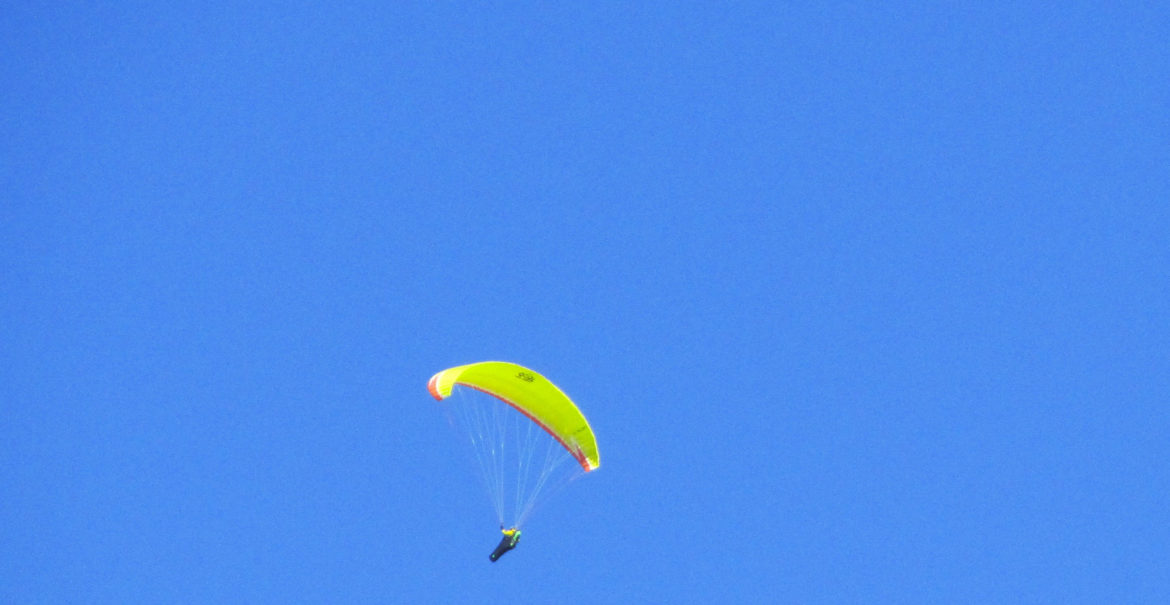 person gliding in blue sky