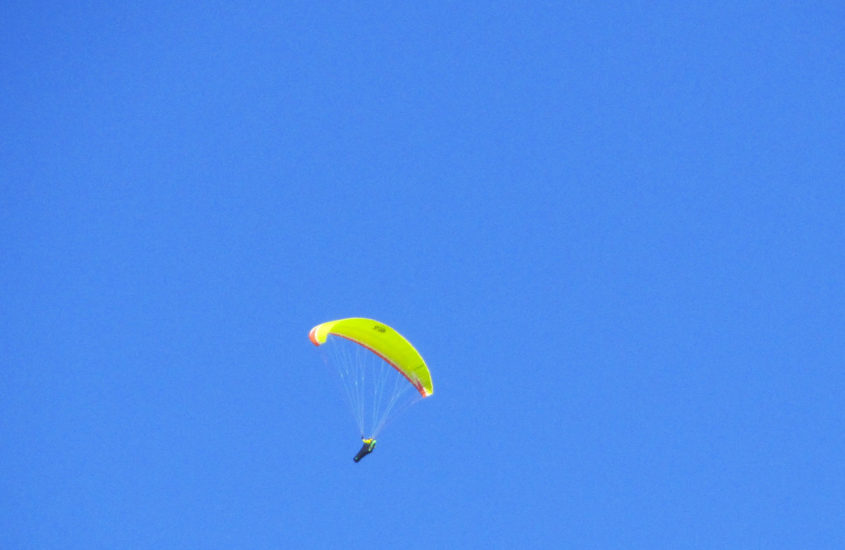 person gliding in blue sky